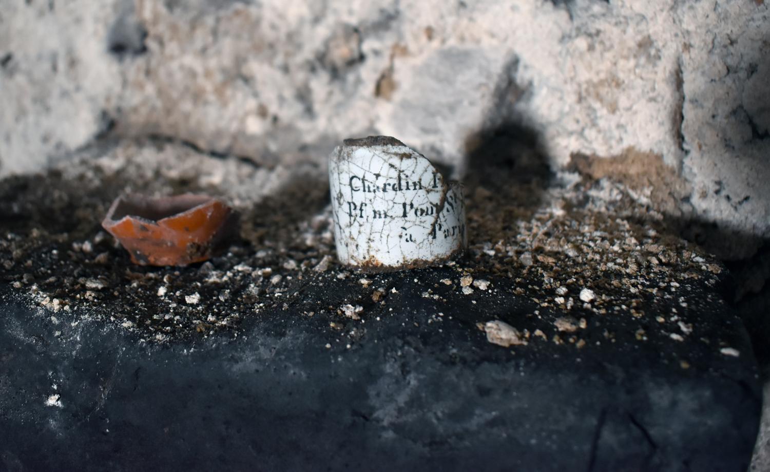 Caves nord : salle n°11, tesson de céramique et cul de flacon de parfum au nom de Chardin